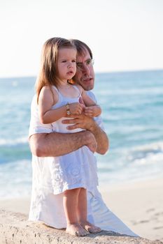 happy family father and daughter on beach having fun summer vacation