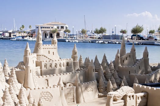 creative big sandcastle on the beach in summer blue sky