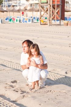 happy family father and daughter on beach having fun summer vacation