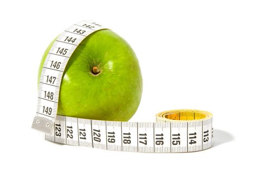 Green apple with measure tape over white background