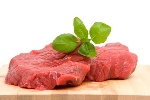 Raw steak meat on cutting board over white background