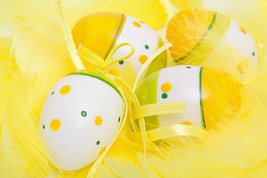 closeup of easter eggs in yellow feathers