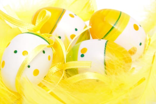 closeup of easter eggs in yellow feathers