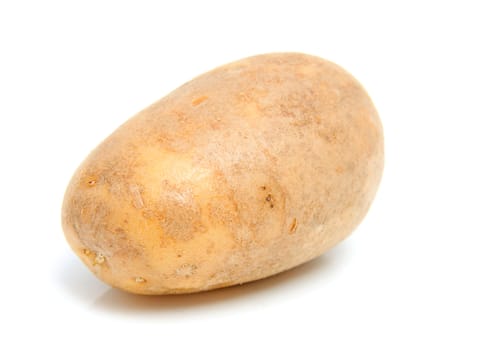 One unpeeled raw potato over white background