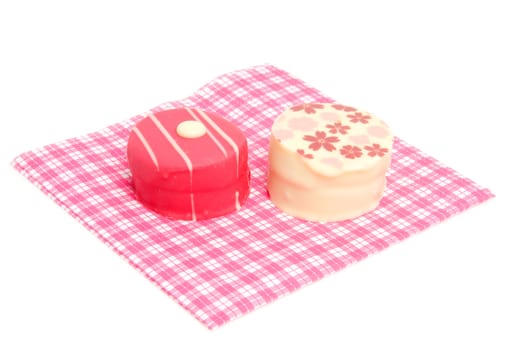petit four on checkered napkin over white background