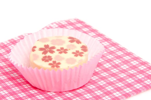petit four on checkered napkin over white background