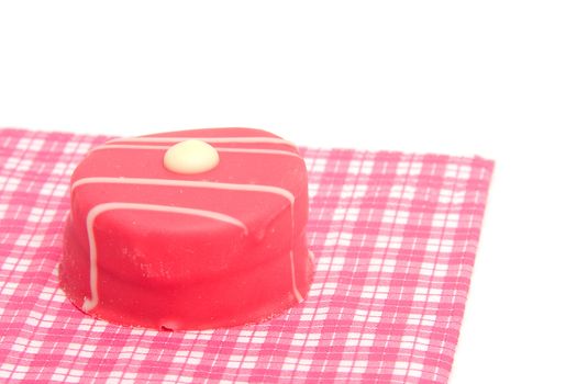 petit four on checkered napkin over white background