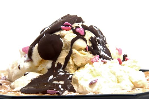 delicious dessert with waffle and ice cream on black plate over white background