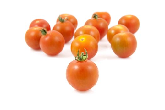 Bunch of fresh cherry tomatoes over white background