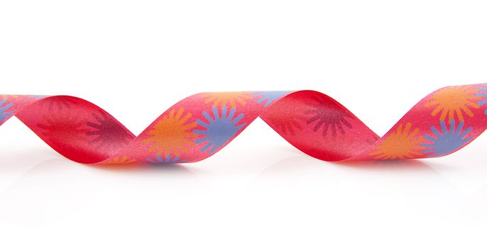 Colorful curly streamer in closeup over white background