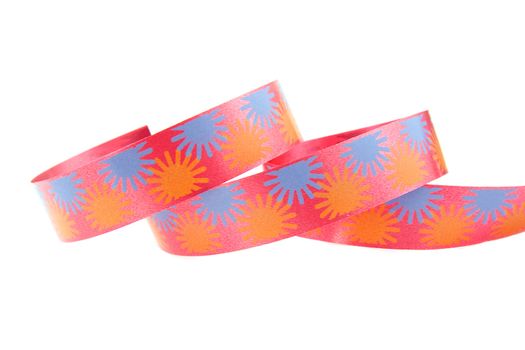 Colorful curly streamer in closeup over white background