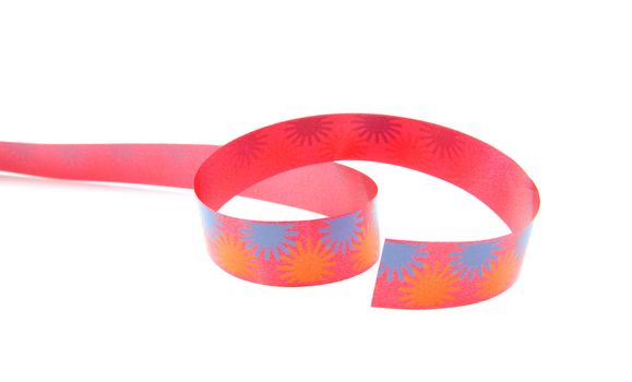 Colorful curly streamer in closeup over white background