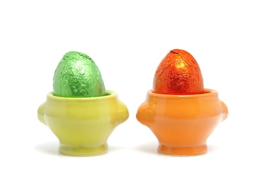 colorful easter eggs in cups isolated on white background