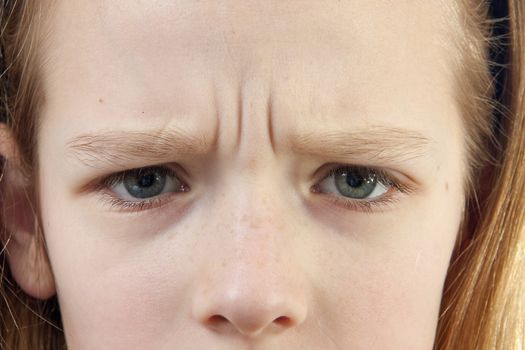 Closeup of a girl who looks angry, only see her eyes