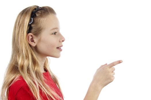 Young blonde girl points to  something over white background