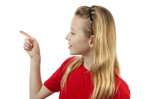 Young blonde girl points to  something over white background
