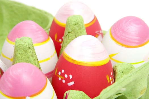 Pink easter eggs in green carton box