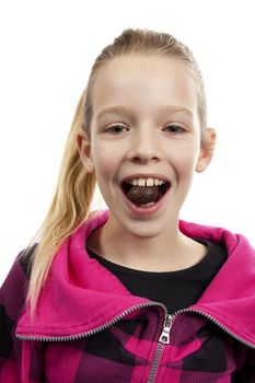 Girl is eating chocolate easter egg over white background