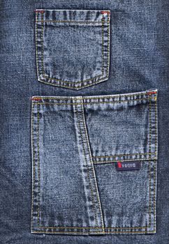 Colose up of blue jeans pockets.