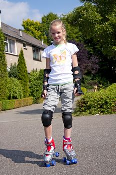 Young blonde girl on roller skate heaving fun