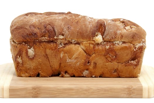baked sugar bread in closeup on cutting board over white background