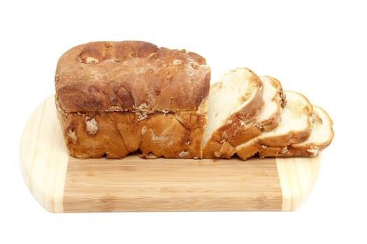 baked sugar bread in closeup on wooden cutting board over white background