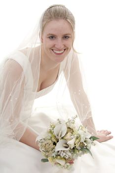 Young beautiful bride with bouquet is smiling over white background
