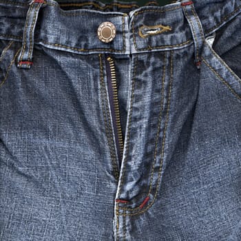 Detail of zipper on blue jeans close up