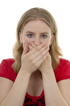 Young blonde woman covers her mouth: speak no evil, isolated on white background