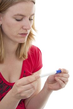 Woman with pregnancy tast is waiting for the result over white background