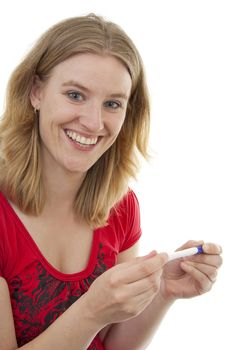 Woman with pregnancy tast is smiling because she is pregnant, over white background