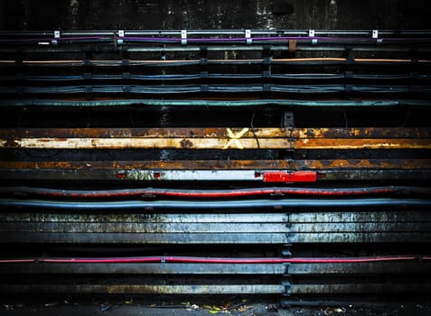 Electric cables on a grungy concrete wall with vignette