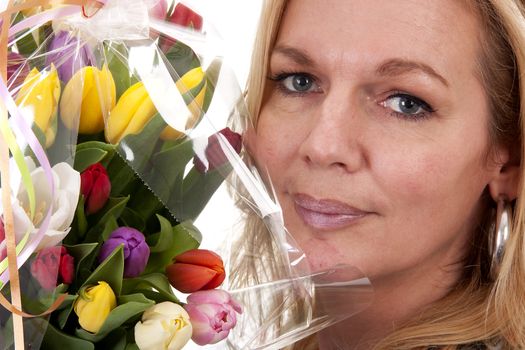 Woman with Dutch tulip flowers in closeup over white background