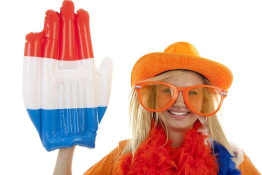 portrait of Dutch soccer fan in orange outfit with big glasses, hat and big hand over white background