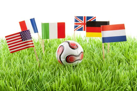 Flags and ball on soccer field over white background
