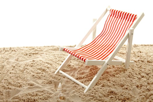Beach chair on sand over white background