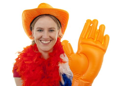 Portrait of Dutch soccer fan in orange outfit with big funny blown up hand posing over white background