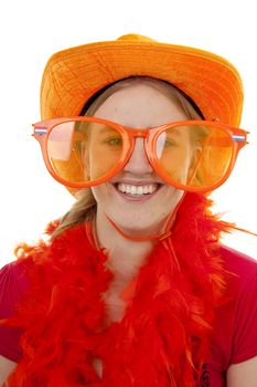 Portrait of Dutch soccer fan in orange outfit with big funny glasses posing over white background