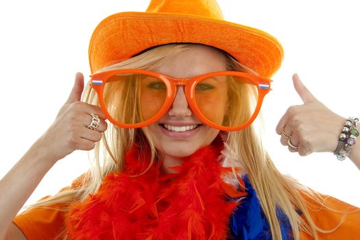 Portrait of Dutch soccer fan in orange outfit with big funny glasses and thumbs up posing over white background