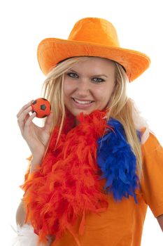 Portrait of Dutch soccer fan in orange outfit posing over white background holding ball