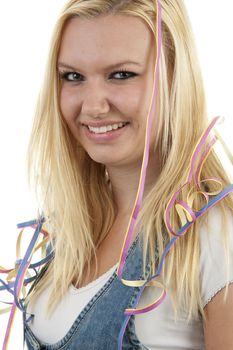Birthday girl with party streamers over white background