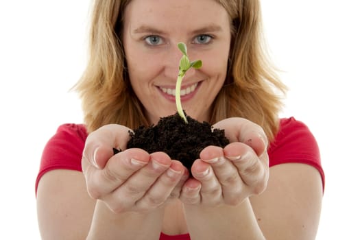 Woman is holding Pile of black garden soil with young plant for new life over white background