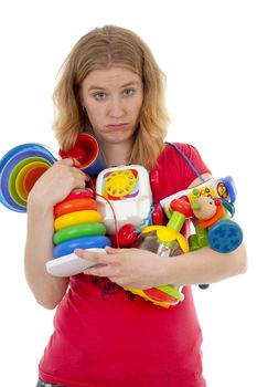 Woman with lots of colorful toys is looking tired  over white background