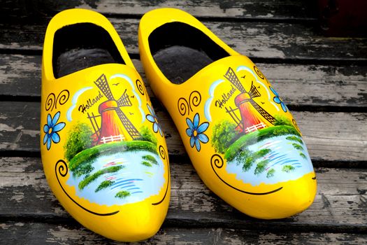 Painted typical Dutch yellow wooden shoes in closeup