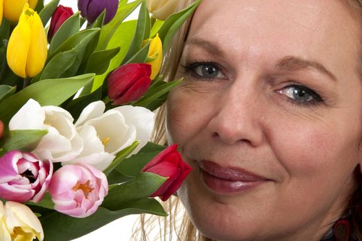 Woman with Dutch tulip flowers in closeup over white background