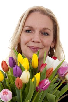 Woman with Dutch tulip flowers in closeup over white background