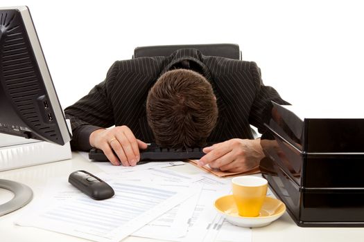 Businessman lies with head on his desk, overwrought and sleeping, over white background