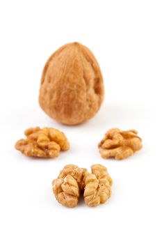 pieces and whole walnut isolated on white background