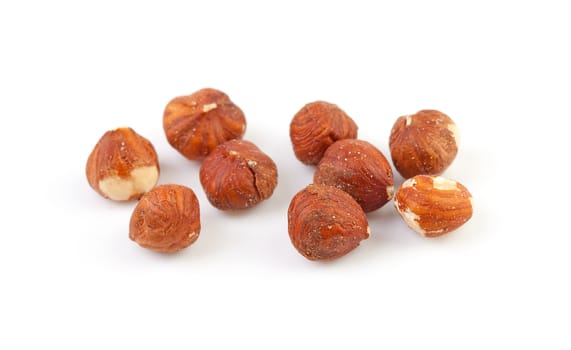 Some peeled hazelnuts isolated on white background