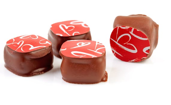 four chocolate bonbons isolated on white background